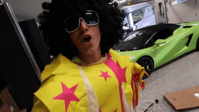 a man in an afro wig and sunglasses is standing in front of a green car