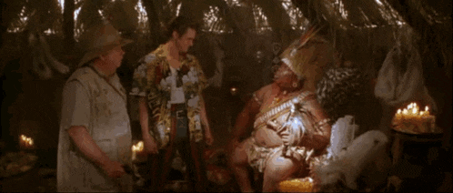 a man in a hawaiian shirt is talking to a man in a native american outfit