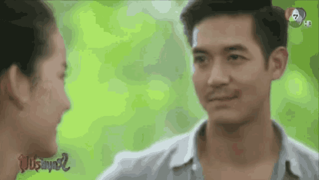 a man and a woman are looking at each other in a blurry photo