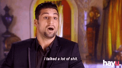 a man in a suit is talking about talking a lot of shit