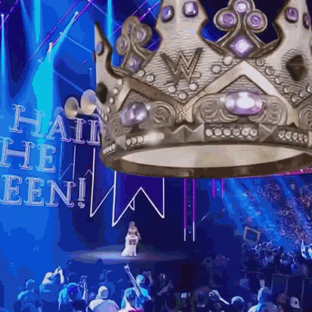a woman stands on a stage with a crown above her and the words haii the eeni