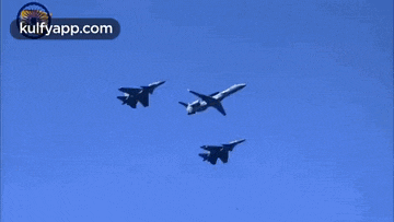 three fighter jets are flying in formation in a blue sky with the website kulfyapp.com in the corner