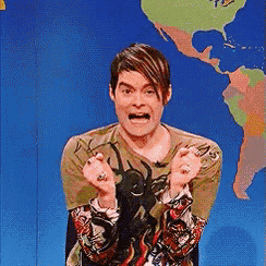 a man is making a funny face in front of a map