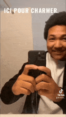 a man is taking a picture of himself in a bathroom mirror .