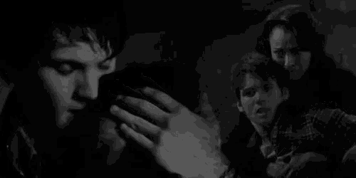 a man is holding another man 's hand in a black and white photo