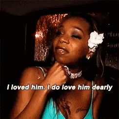 a woman with a flower in her hair is talking about a man .