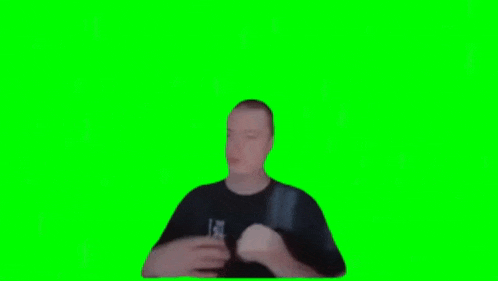 a man is making a funny face on a green screen .