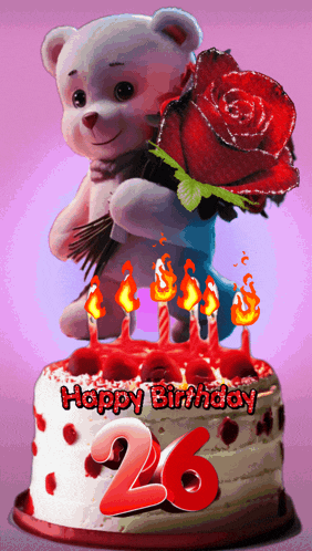 a teddy bear holding a red rose on top of a birthday cake