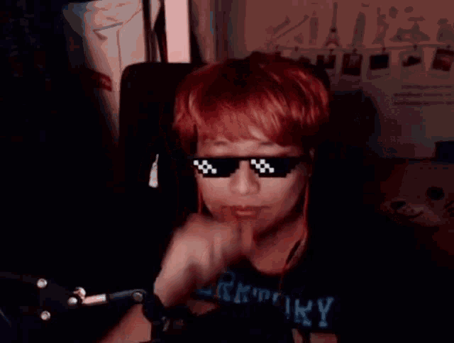 a man wearing sunglasses and a black shirt that says territory