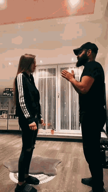 a man and a woman are standing in a living room