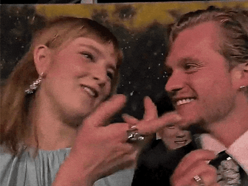 a man and a woman are touching each other 's faces