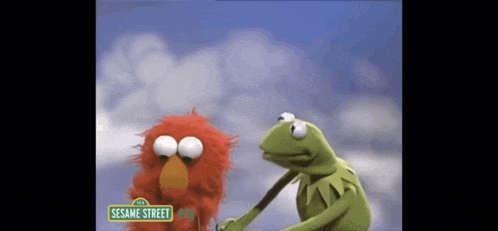 two sesame street characters elmo and kermit are standing next to each other