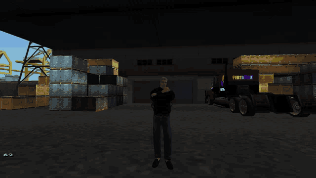 a man in a black shirt stands in front of a warehouse with a truck that says pertamina