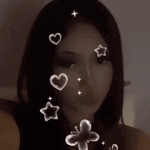 a close up of a girl 's face with hearts , stars , and a hello kitty on it .