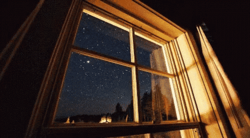 a window with a view of the night sky
