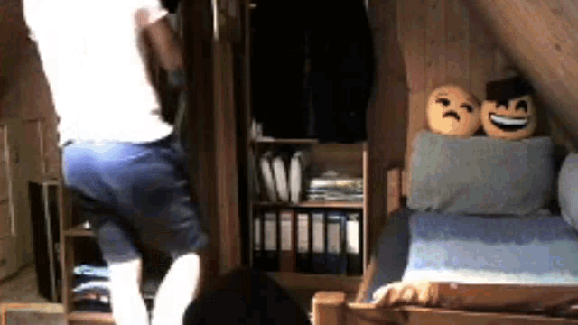 a man is standing in a room with a closet and a bed