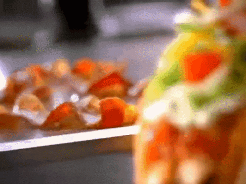 a blurred image of a plate of food with a few pieces of meat on it