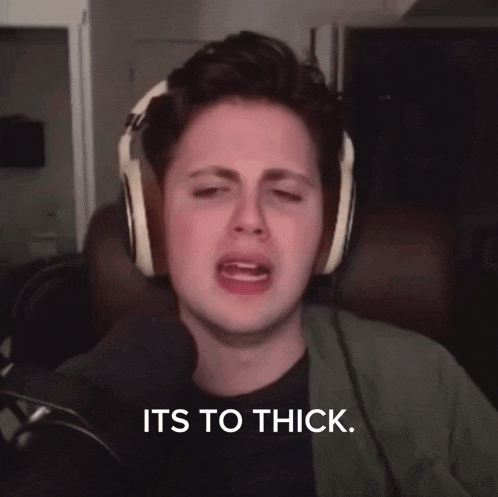 a man wearing headphones says " its to thick " in front of a microphone