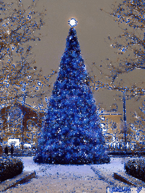 a pixelated image of a blue christmas tree with a star on top