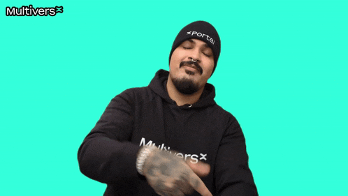 a man giving a thumbs up wearing a black multivers sweatshirt