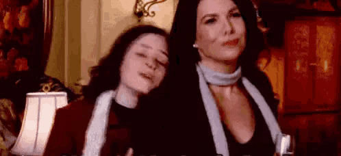 a couple of women are standing next to each other in a room .