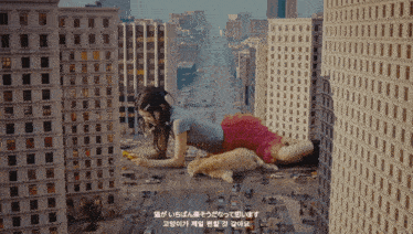a woman laying on top of a cat in a city with foreign writing