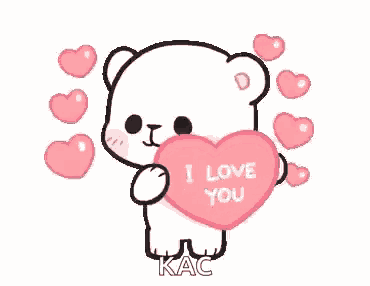 a teddy bear is holding a heart that says `` i love you '' .