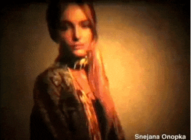 a woman 's face is shown in a blurry photo with the name snejana onopka at the bottom