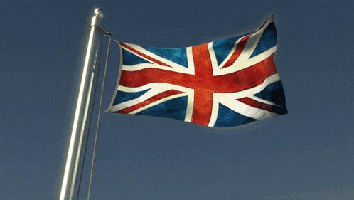 a british flag is flying in the wind