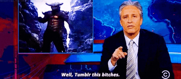 a man in a suit and tie is standing in front of a screen with a picture of a monster and says well tumblr this bitches