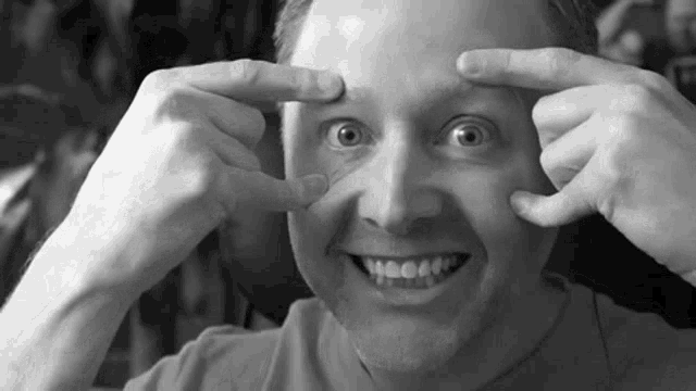 a man is making a funny face with his hands