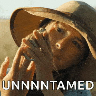 a woman in a hat is holding a sea shell and the word unnntamed is behind her