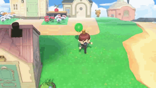 a video game character is holding a green balloon in a grassy area .