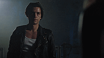 a man in a black leather jacket and white tank top