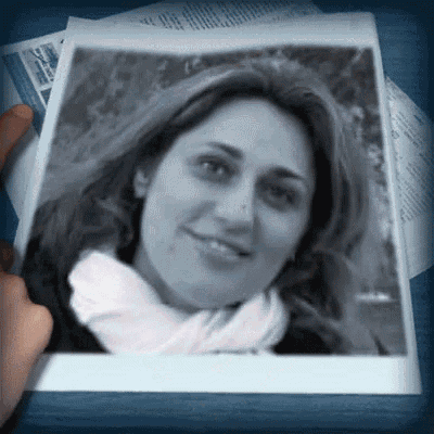 a person is holding a black and white photo of a smiling woman