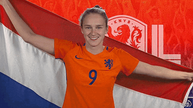 a woman in an orange jersey with the number 9 on it