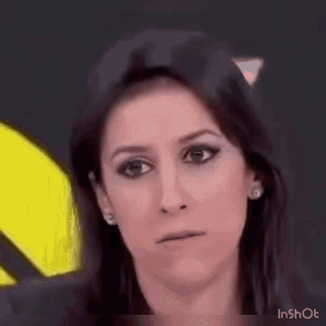 a woman is making a funny face with her mouth open .