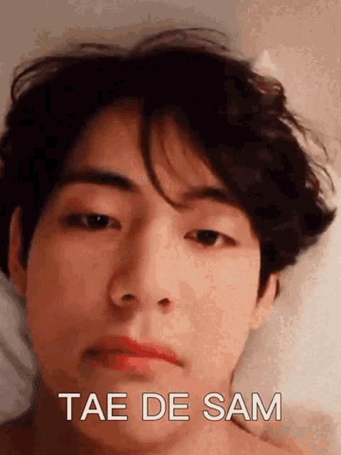 a close up of a person 's face with the words tae de sam written next to it .