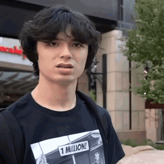 a man wearing a black shirt that says 1 million on it