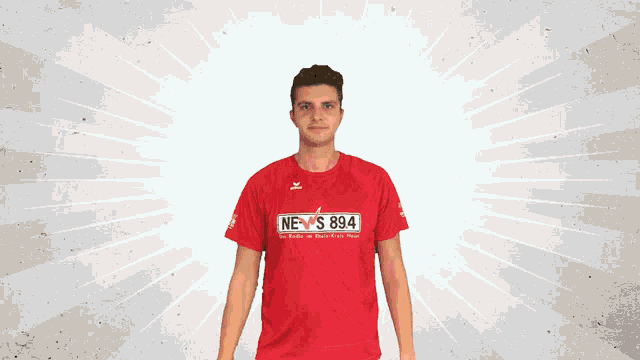 a man in a red shirt that says news 894