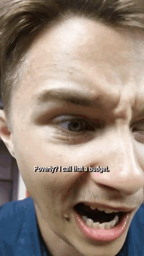 a close up of a man 's face with the words poverty i call that a budget below him
