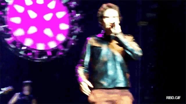 a blurry photo of a man on a stage with the words rbd.gif on the bottom