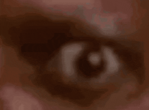 a close up of a person 's eye with a red background