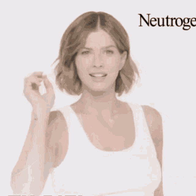 a woman in a white tank top is giving the peace sign .