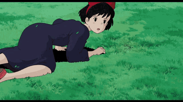 a girl in a blue dress is laying on the grass