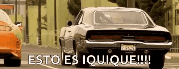 a dodge charger is driving down a street with the words esto es iquique