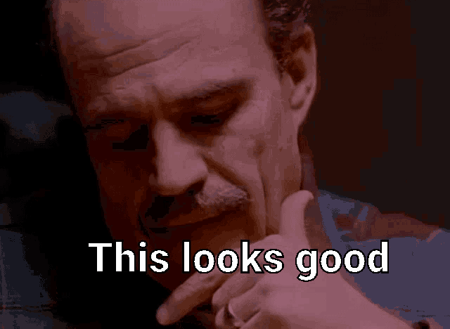 a close up of a man 's face with the words " this looks good " above him