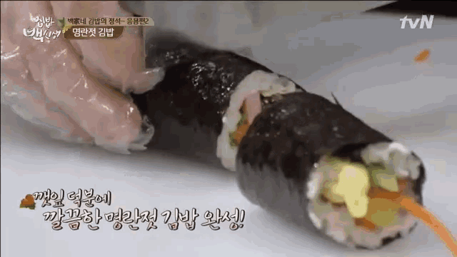 a close up of a sushi roll with a tvn logo in the corner