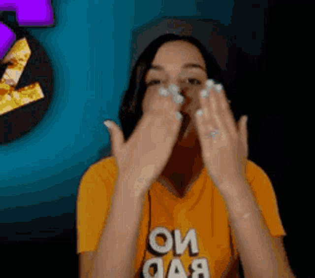 a woman wearing an orange shirt that says oi oaa