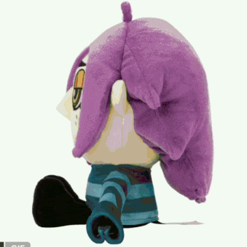 a stuffed animal with purple hair and a blue shirt